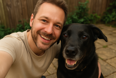 a man with his black dog a selfie style shot